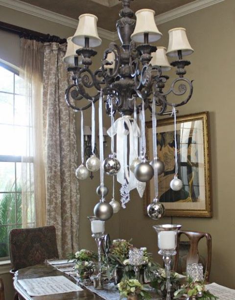 silver and metallic grey ornaments hanging on the chandelier