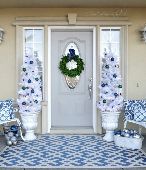 navy, blue and white Christmas porch decor with ornaments and white trees in urns