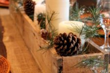 35 rustic wooden box centerpiece with candles, pinecones and evergreens
