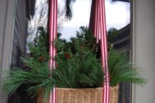 36 a basket with evergreens and striped ribbon