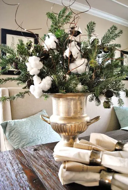 cotton and greens arrangement in a gold bucket