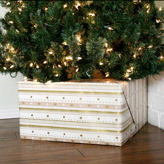 cover your tree base with a gift box for a glam look, and if you don't have any, you can take a usual box and cover it with some colorful paper