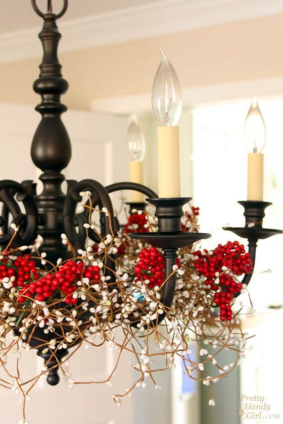 A mid century modern chandelier covered with berries