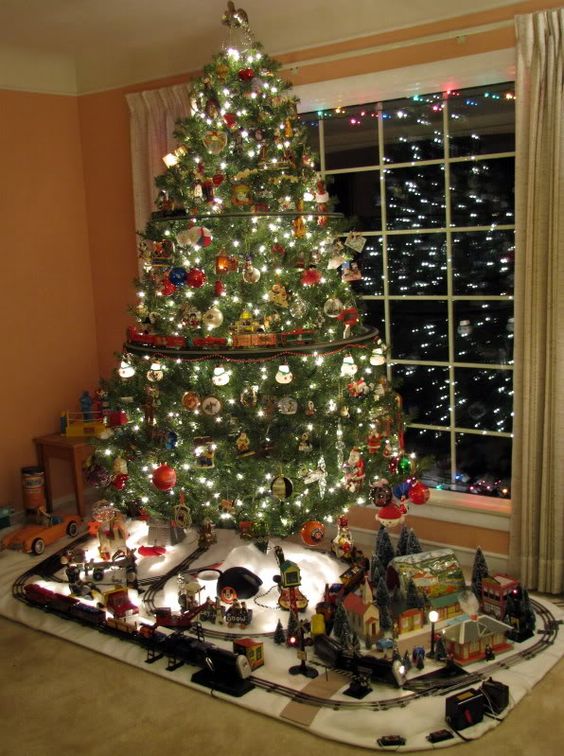 create a whole scene at the base of your tree to make the kids and adults happy, it's like a decoration and an activity in one
