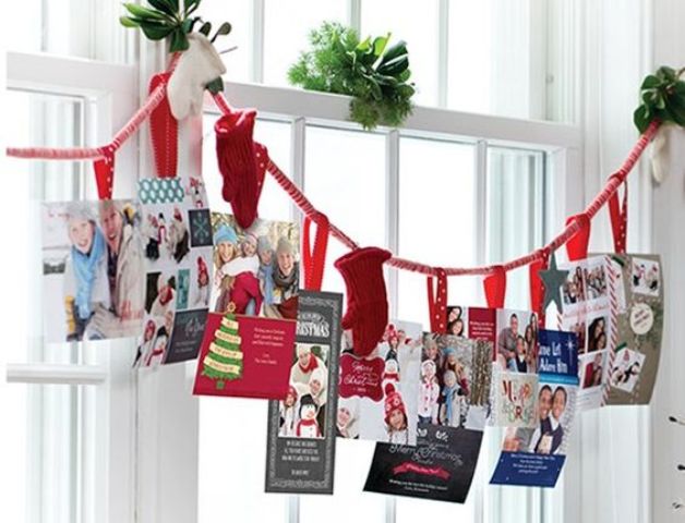 holiday card display on a garland with mittens