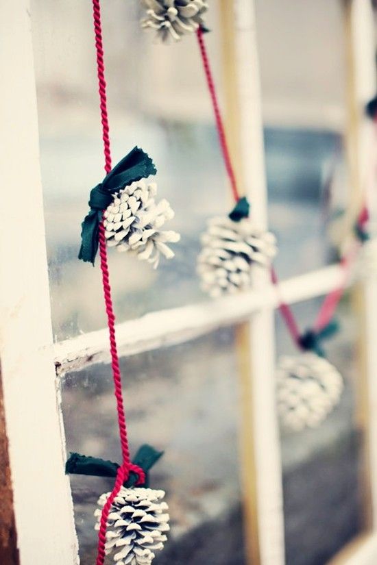 white pinecones on red strings for a simple and eye-catchy garland