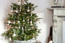 put an Xmas tree in a high pot, this way a small or not tall tree will look larger and taller and you will be able to place gifts under it