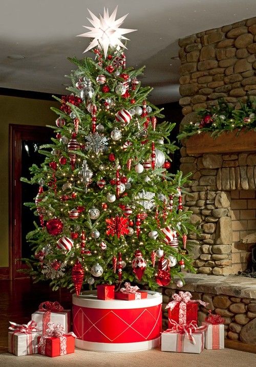 A drum inspired gift box that covers the tree base is a super bold and colorful statement and decor idea for a Christmas tree