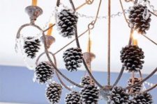 39 hang snowy pinecones on the chandelier