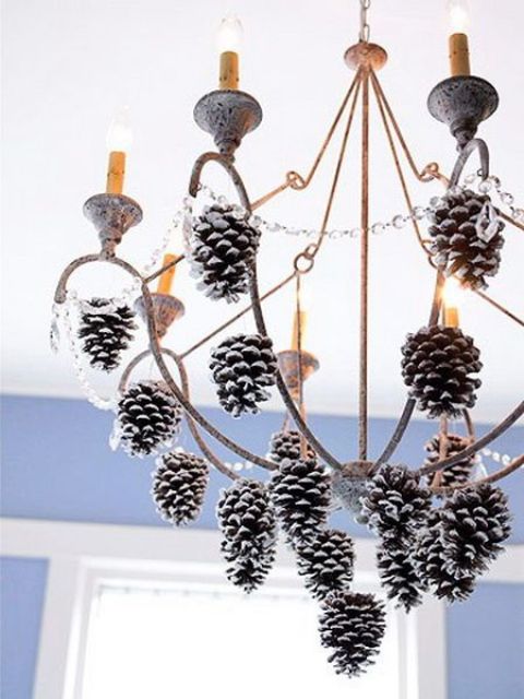 hang snowy pinecones on the chandelier
