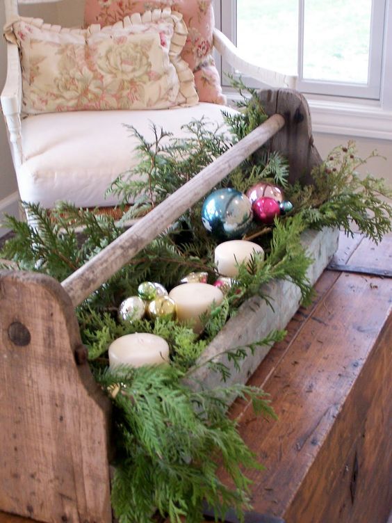 vintage toolbox repurposed for holiday decor with fir branches, candles and ornaments