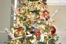a bright rustic Christmas tree with lights, branches, plaid and polka dot ornaments and metallic ones, too plus a plaid cover