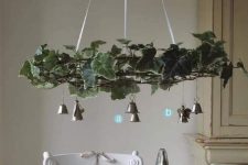 a catchy Christmas chandelier with vines and silver bells is a beautiful vintage holiday decor idea to rock