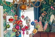 a classy gold chandelier decorated with colorful vintage ornaments is a cool and chic decoration with plenty of color