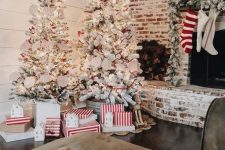 a duo of flocked Christmas trees with lights, star toppers, paper buntings makes a holiday statement