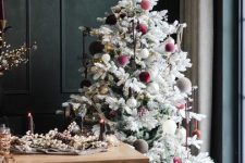 a flocked Christmas tree with pink, burgundy and white velvet ornaments and a star topper is bright and great