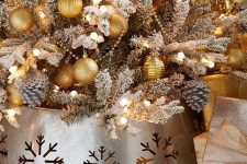 a galvanized metal tree collar with laser cut snowflakes is a great finishing touch for your tree