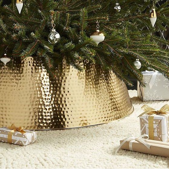a glam bash gold tree collar will raise your Christmas tree decor to a new level