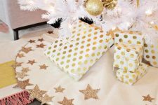 a gorgeous white Christmas tree skirt with glitter star detailing is a cool and catchy idea for the holidays