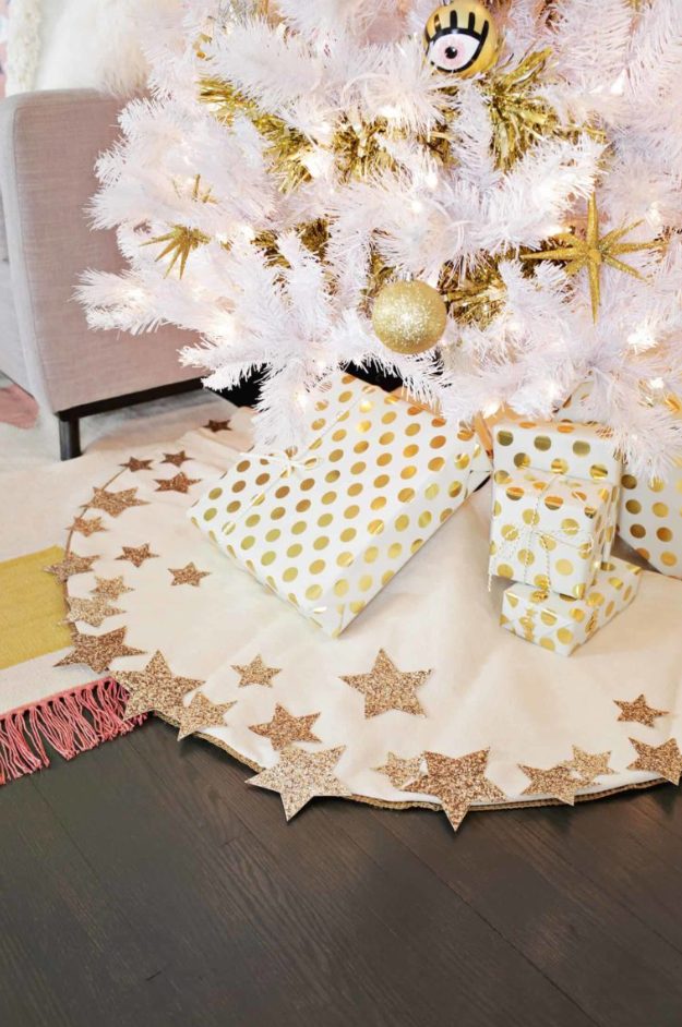 a gorgeous white Christmas tree skirt with glitter star detailing is a cool and catchy idea for the holidays