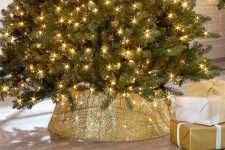 a mesh lighted Christmas tree collar will add a shiny touch and light up the tree