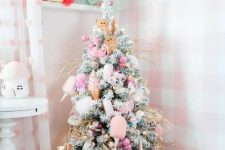 a pastel Christmas tree with lights, pink ornaments and various cuties like donuts, gingerbread men and ice cream
