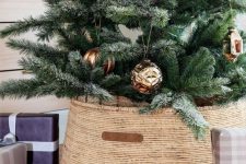 a pretty seagrass basket with leather is a cool solution for a rustic Christmas tree, it looks very nice