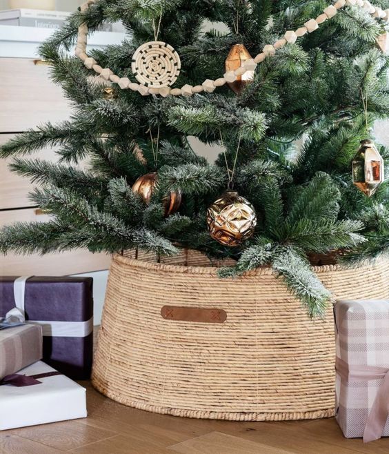 a pretty seagrass basket with leather is a cool solution for a rustic Christmas tree, it looks very nice