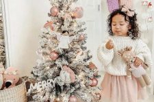 a small Christmas tree decorated with blush ornaments, angels and unicorns is a very cute idea for a little girl’s room