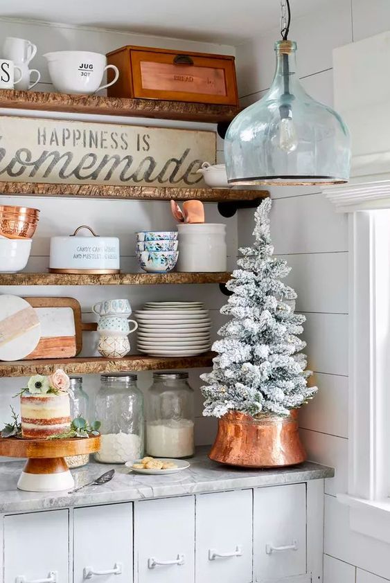a small flocked Christmas tree with a copper tree collar looks elegant and is amazing for a farmhouse space
