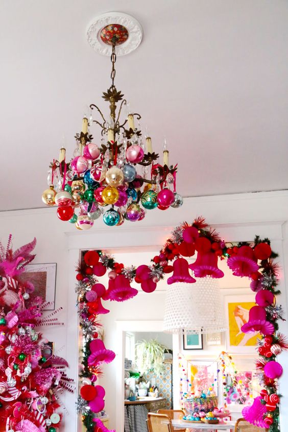 A vintage chandelier with colorful ornaments is a cool and catchy idea for a bright and color filled space