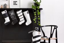 cute modern black and white Cchristmas stockings are perfect to decorate a mantel