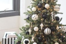 match the color of the tree skirt with the ornaments like here – black and white ornaments and a striped black and white skirt