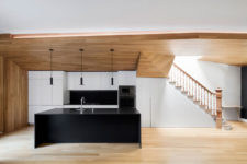 02 Black and white accents give the duplex a modern look, and lots of wood make it cozier and natural-looking