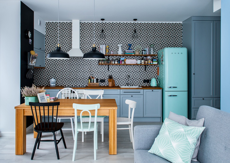 The kitchen has a fantastic graphic tile wall that stands out in the backdrop of pale blue cabinets