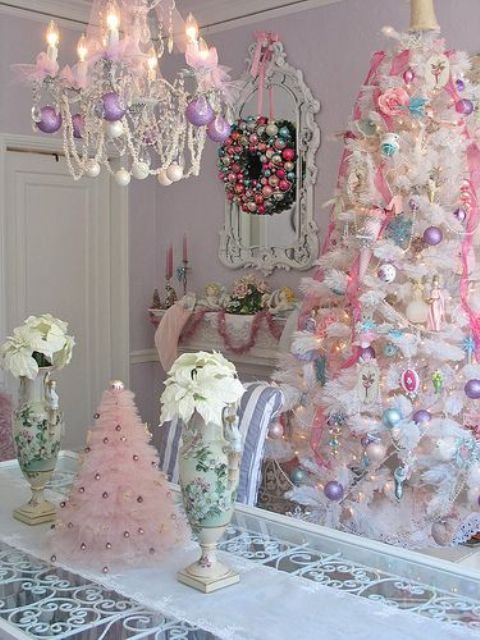 a white tree with pastel ornaments and a pink ruffle tree