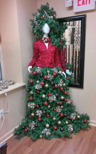 manequin Christmas tree with a red jacket and a tree skirt