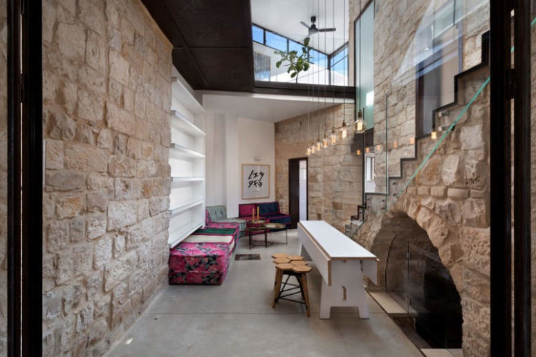 Glass and concrete used with ancient stone makes this house stunning and very eye-catching