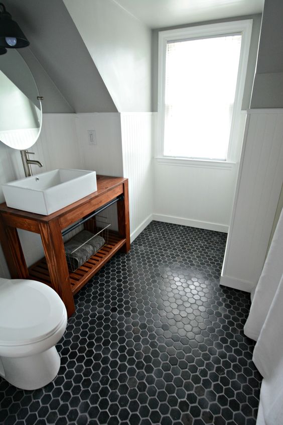 black hex tiles make a statement in this neutral bathroom
