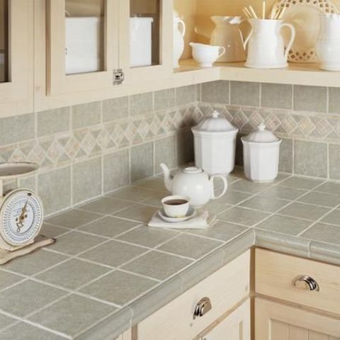 grey tiles on the backsplash and countertops with beige grout