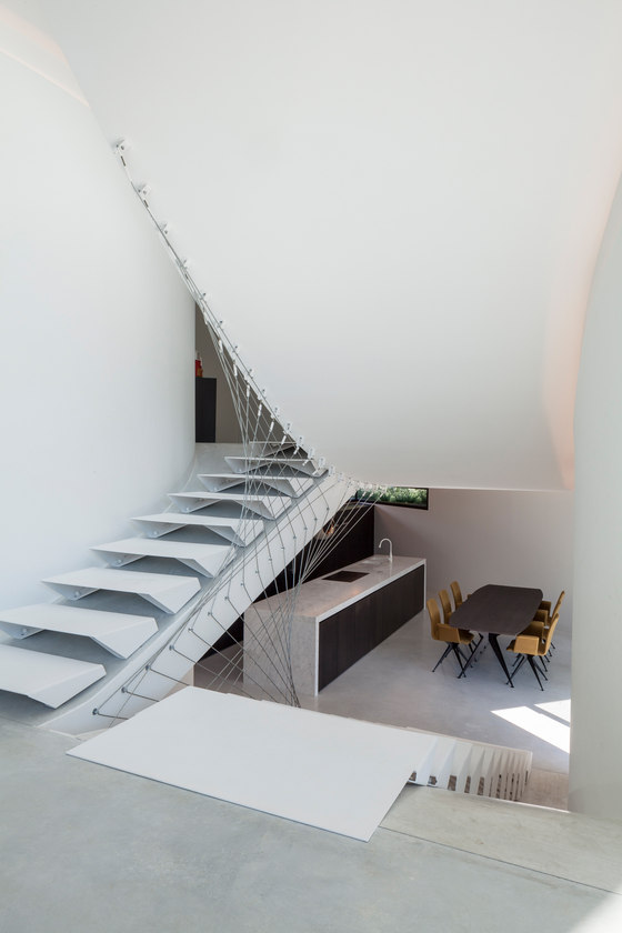 The ladder with geometrical design is one of the focal points of the house