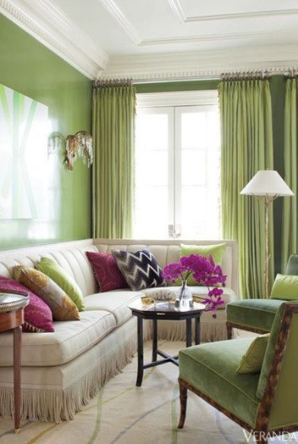 glossy greenery accent wall and curtains, a couple of chairs that echo