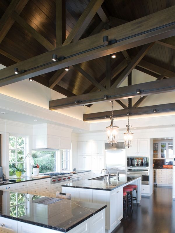 large kitchen with dark wooden beams and track lights