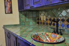 05 bold violet kitchen cabinets and green tiles on the backsplash and countertop