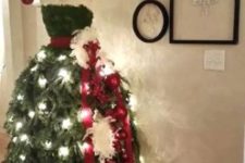 05 elegant dress Christmas tree with lights and a red sash