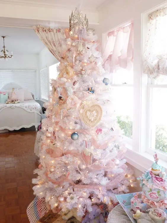 white Christmas tree with lights and pastel ornaments