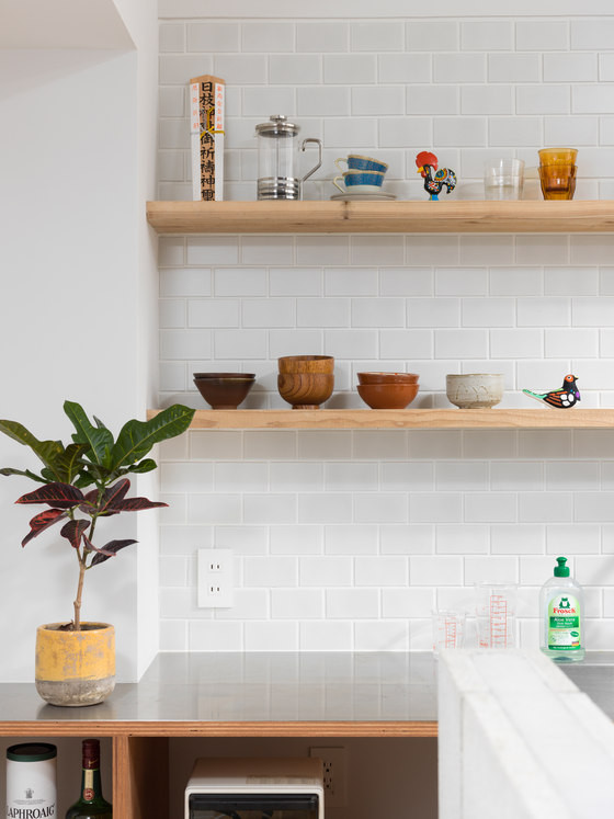 Subway tiles and warm wood shelves look elegant and stylish together