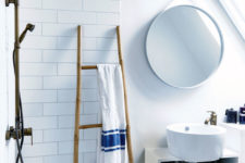 06 The bathroom is modern, clean and white, with wooden and rattan touches