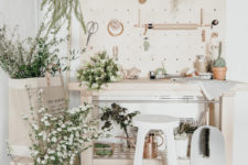 07 The crafting nook features beige and blush furniture and lots of greenery and flowers