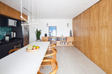 08 The kitchen is rather spacious, with bookshelves that echoes with a wooden panel